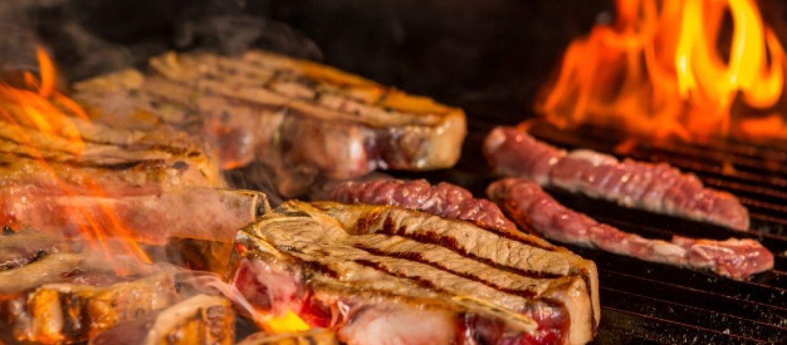 half-grilled-half-ready-raw-steaks-grill_114579-1980